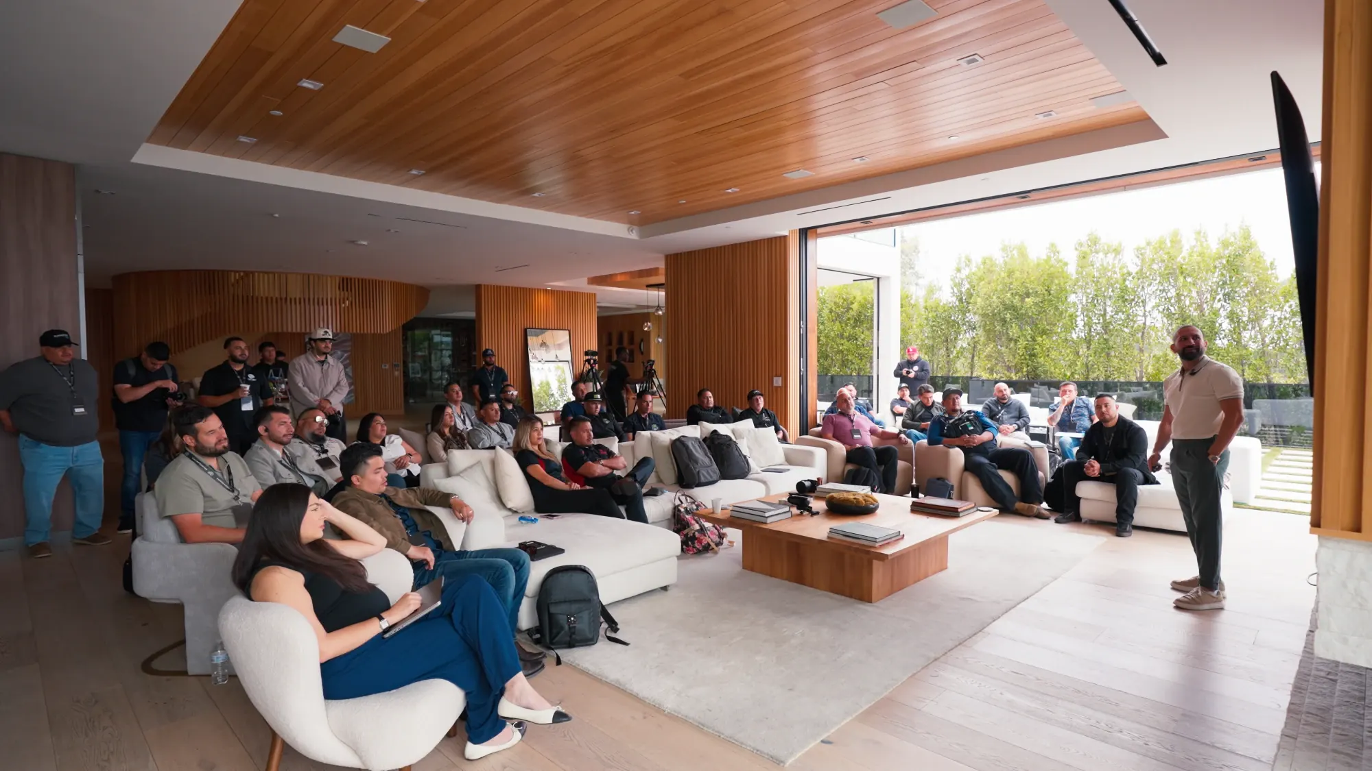Sal Shakir teaching a room of business owners in a living room workshop