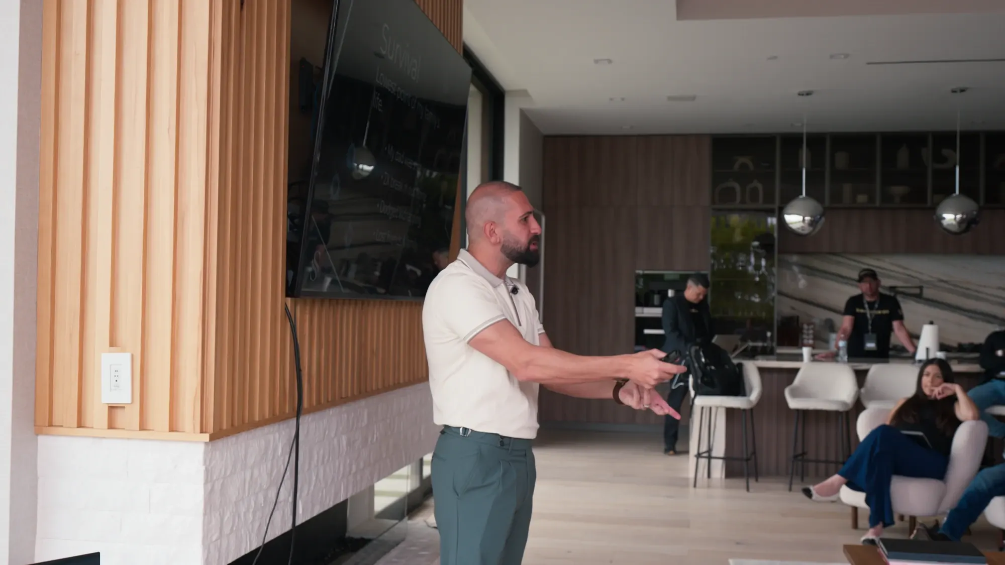 Sal Shakir presenting at an owners event beside a large screen